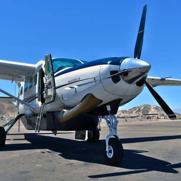 Fly over a UNESCO World Heritage Site Nazca Lines geoglyphs on the desert plateau seen from the flight departing Pisco