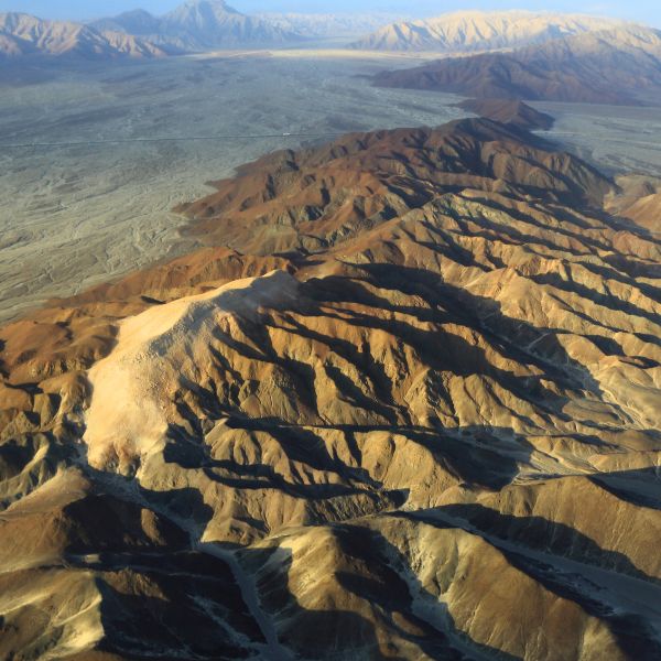 Aerial access to a UNESCO World mystery Nazca Lines stretching across the desert, seen on the flight from Ica