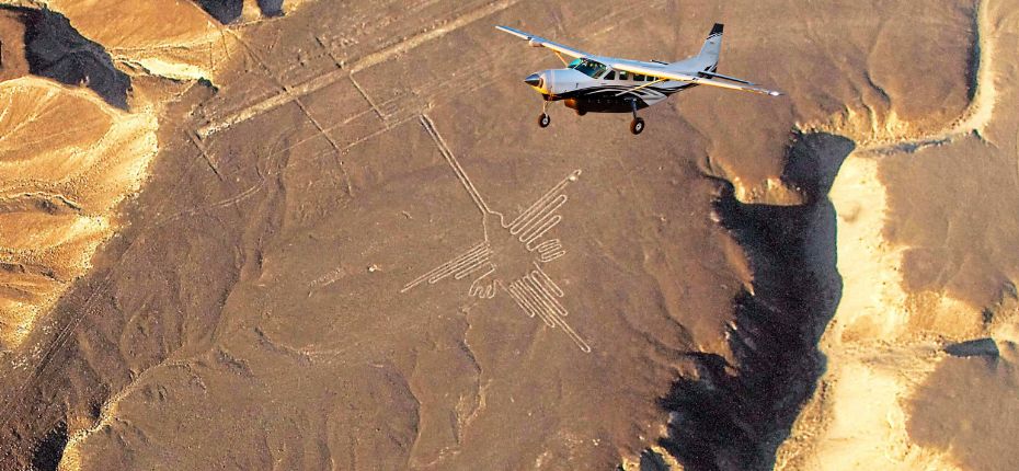 Flight over the Nazca Hummingbird Small plane flying over the Hummingbird geoglyph in the Nazca desert