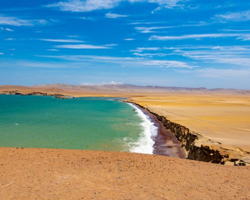 Playa Roja, Paracas National Reserve Red sand of Playa Roja meeting the turquoise Pacific Ocean below the desert cliffs of Paracas