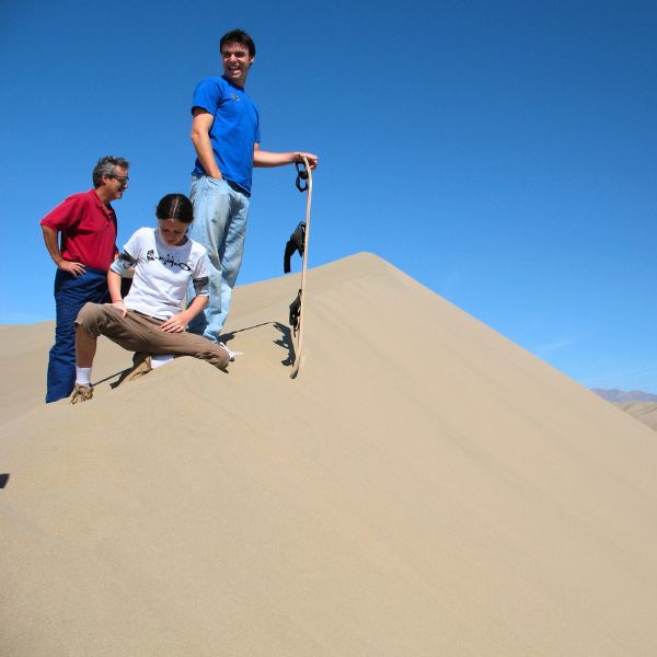 Sandboarders preparing to ride the dunes