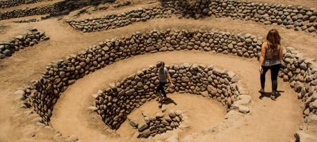 Tourists exploring Cantayo spiral aqueduct in Nazca.