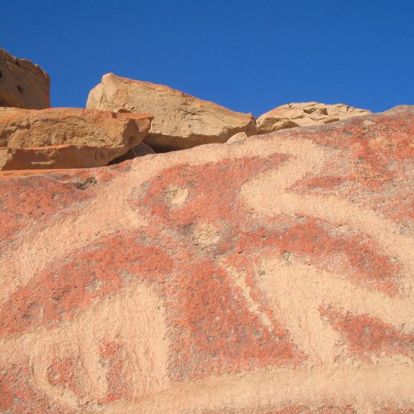Bird figure carved into a red stone surface in the Palpa Valley.